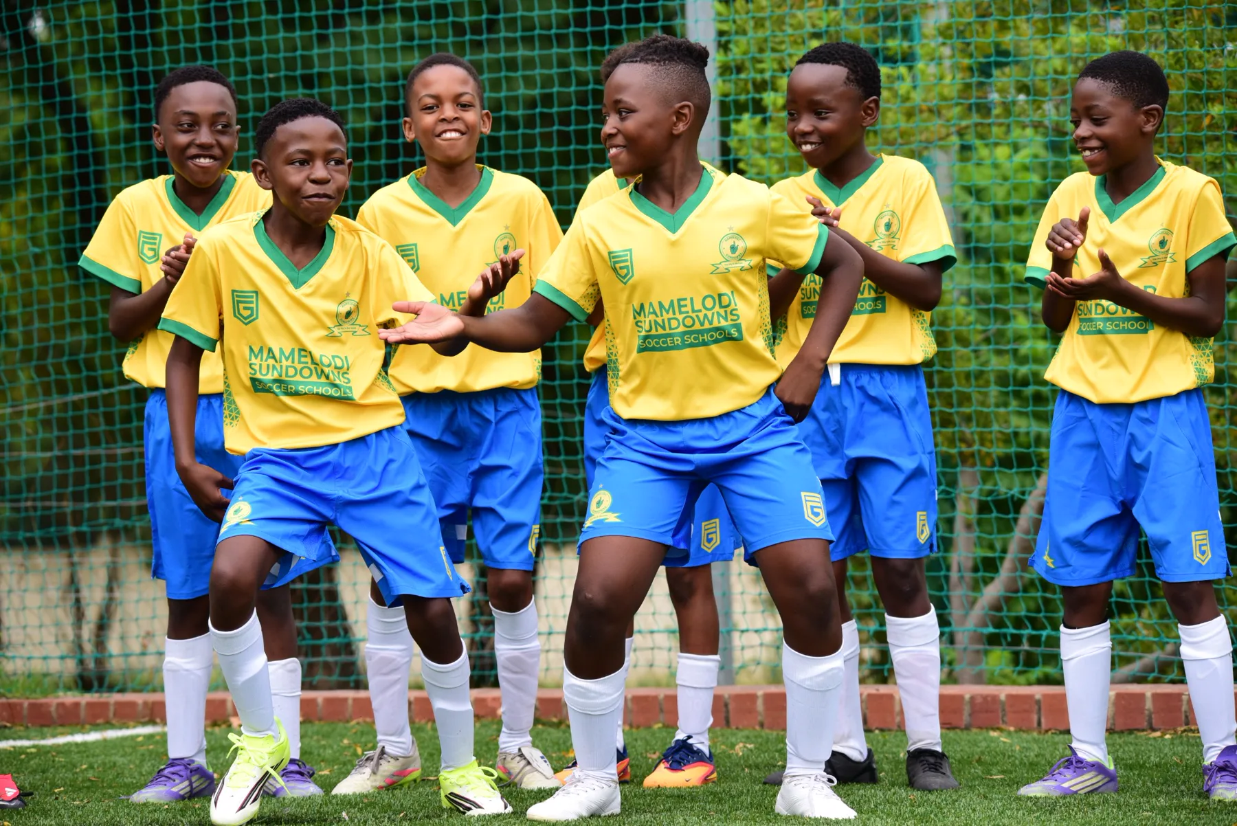 Young Mamelodi Sundowns Soccer Schools players enjoying football together
