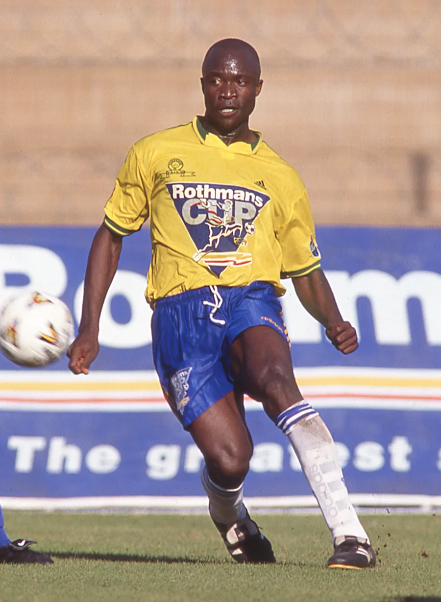 A Mamelodi Sundowns player in a classic yellow kit