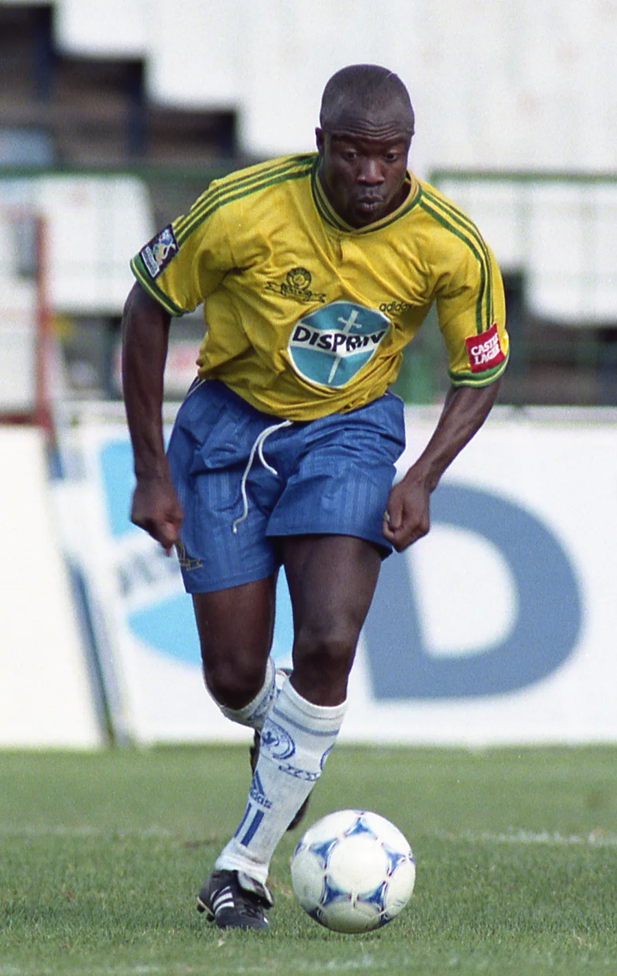 A Mamelodi Sundowns player driving forward with the ball