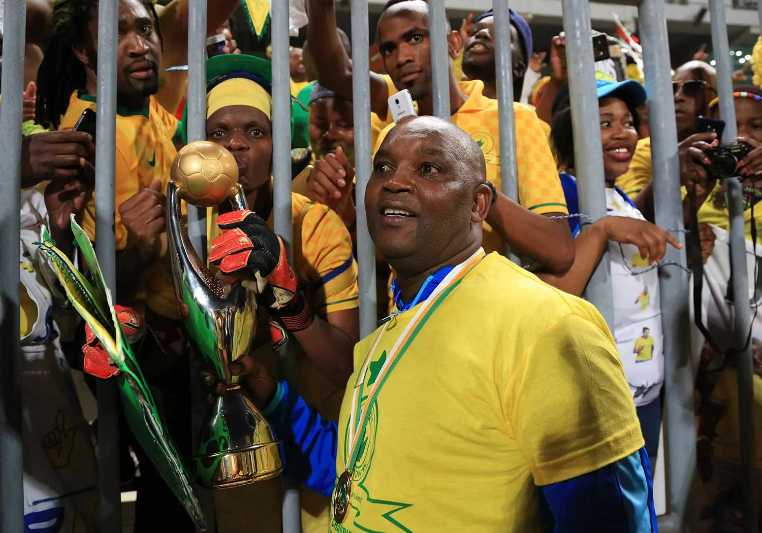 Sundowns carrying the CAF Champions League trophy to supporters