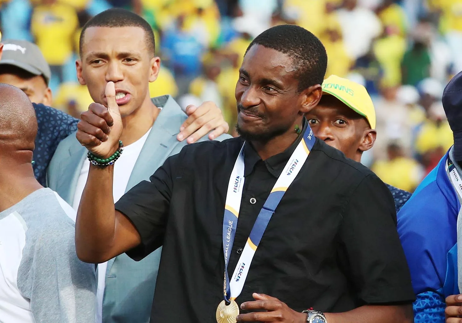 Pitso Mosimane wearing a championship medal