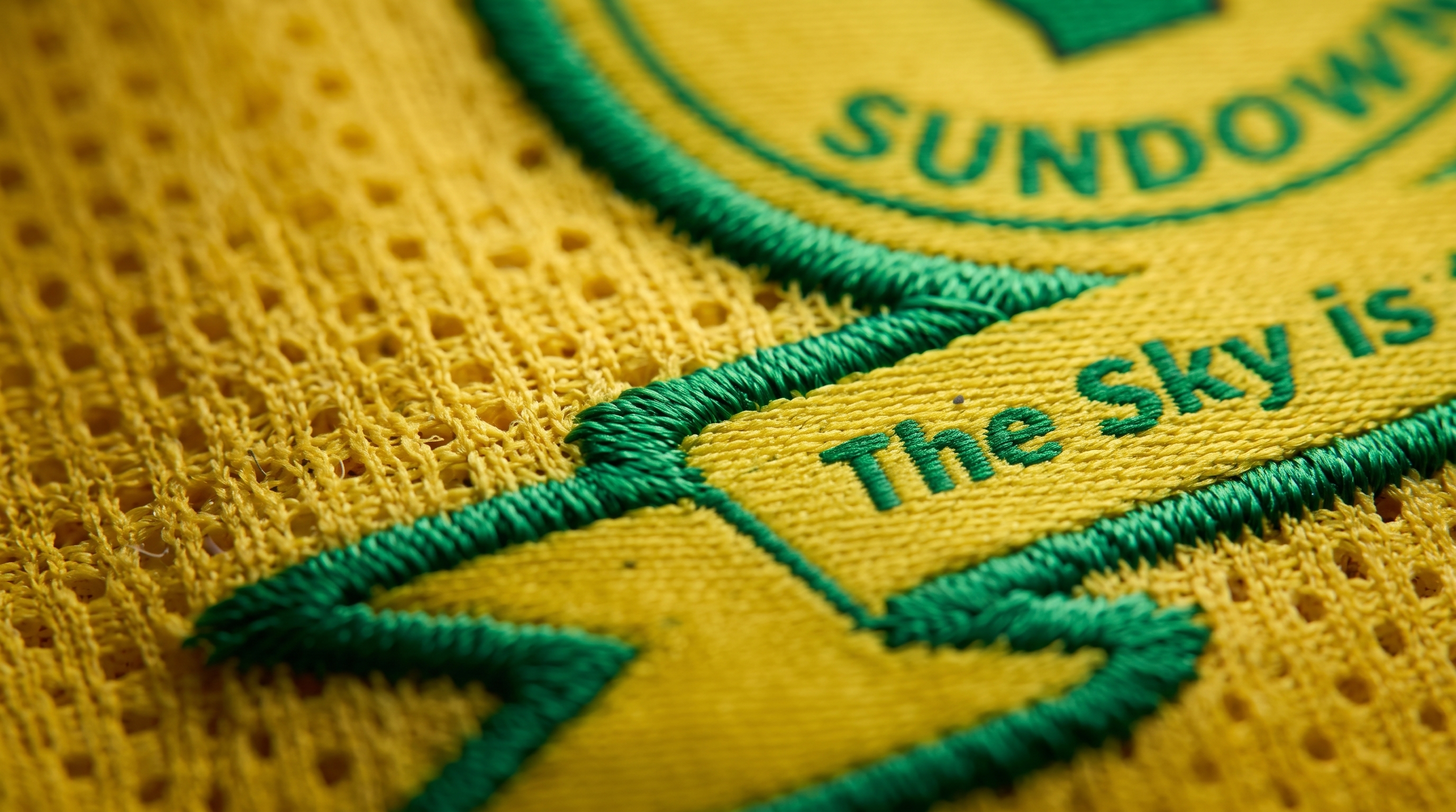 Macro detail of the Sundowns crest and The Sky is the Limit embroidery