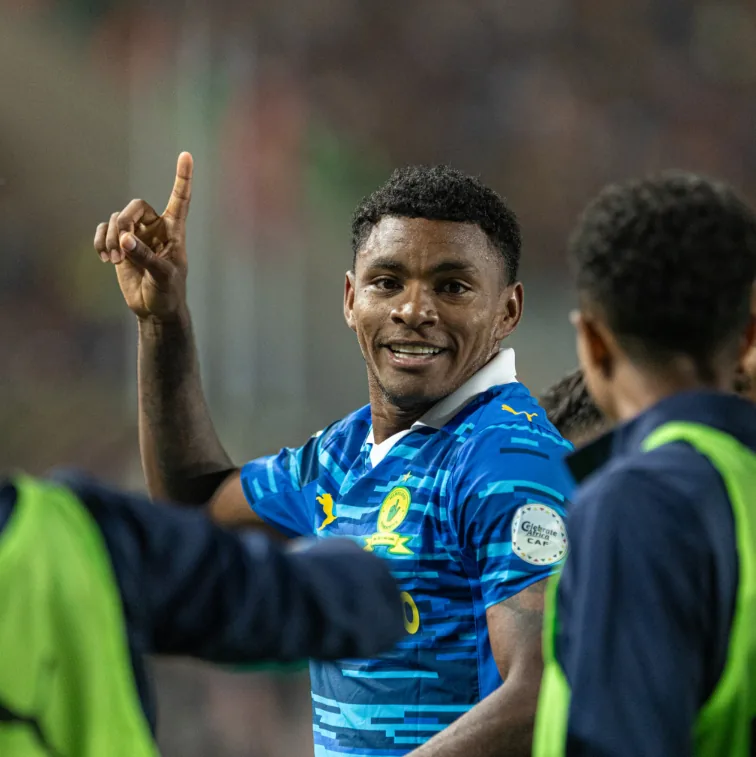 A Sundowns player celebrating in the blue away kit during a continental fixture